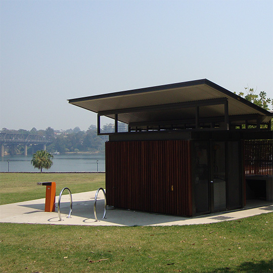 A modern toilet block in a harbour foreshore park.